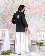 Load image into Gallery viewer, Aafrinish Rimen Hassan Black and white short kurti white sharrara splatter painting back
